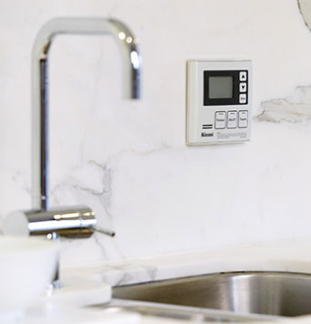 Tap and sink on benchtop with hot water system controls