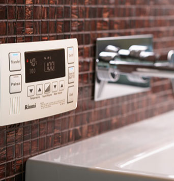 Hot water system controls above tap and sink